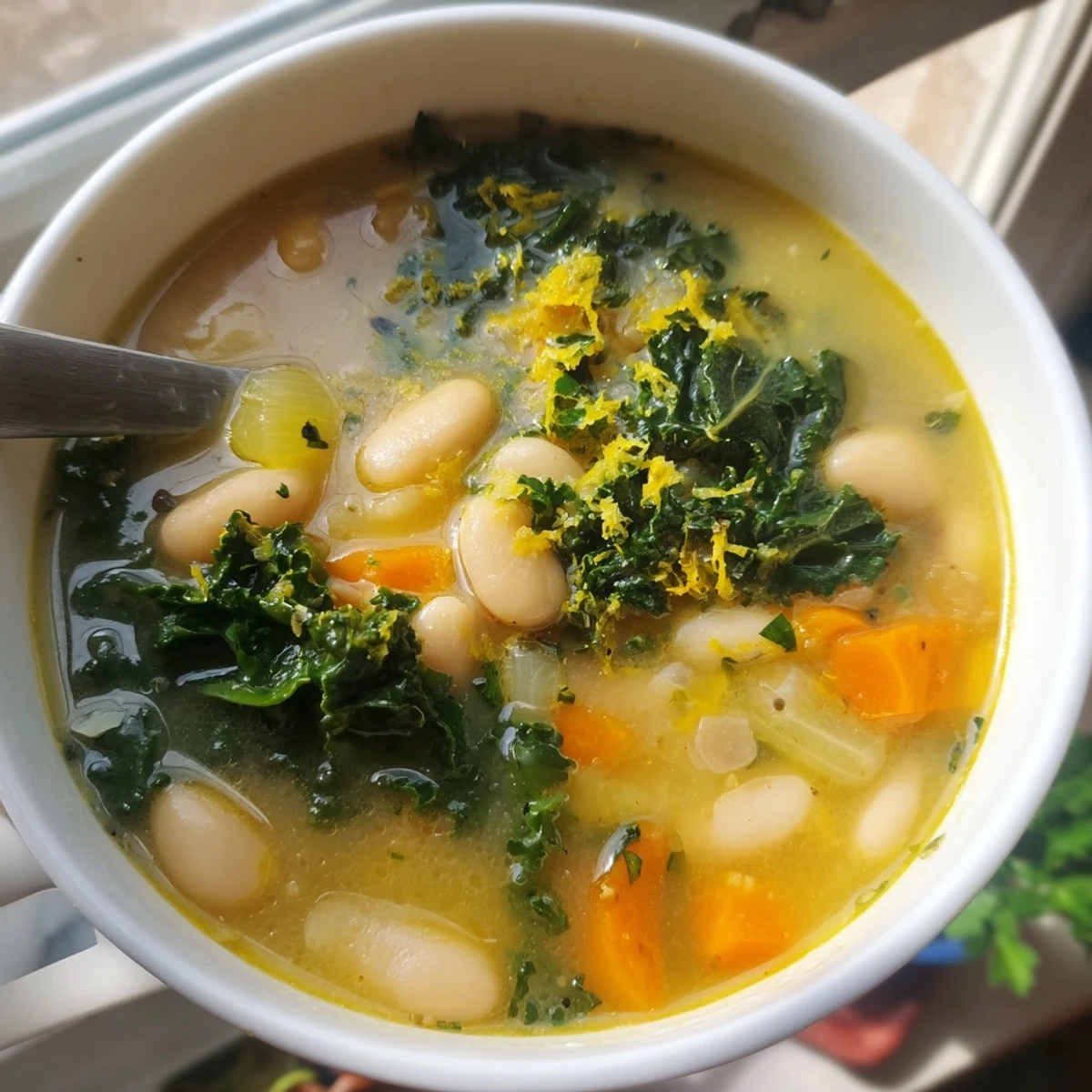 Vibrant Mediterranean White Bean and Kale Soup with Lemon Zest, ideal for a nourishing, easy weeknight vegetarian dinner.