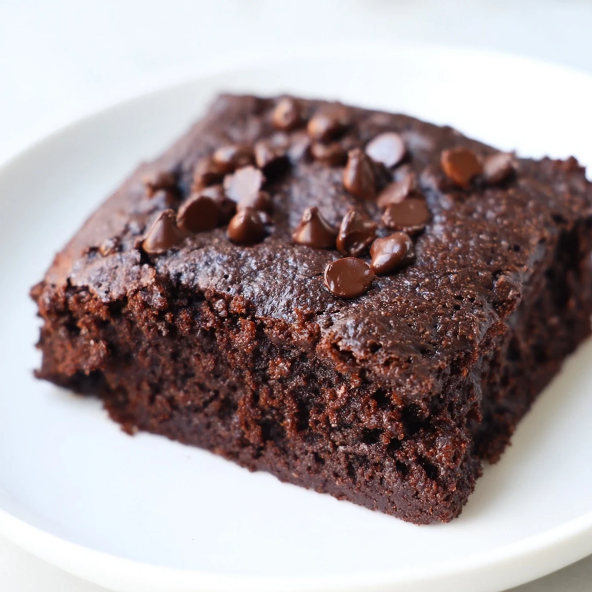 Moist, rich squares of Gluten-Free Almond Flour Brownies cooling on parchment, ideal for a gluten-free chocolate treat.