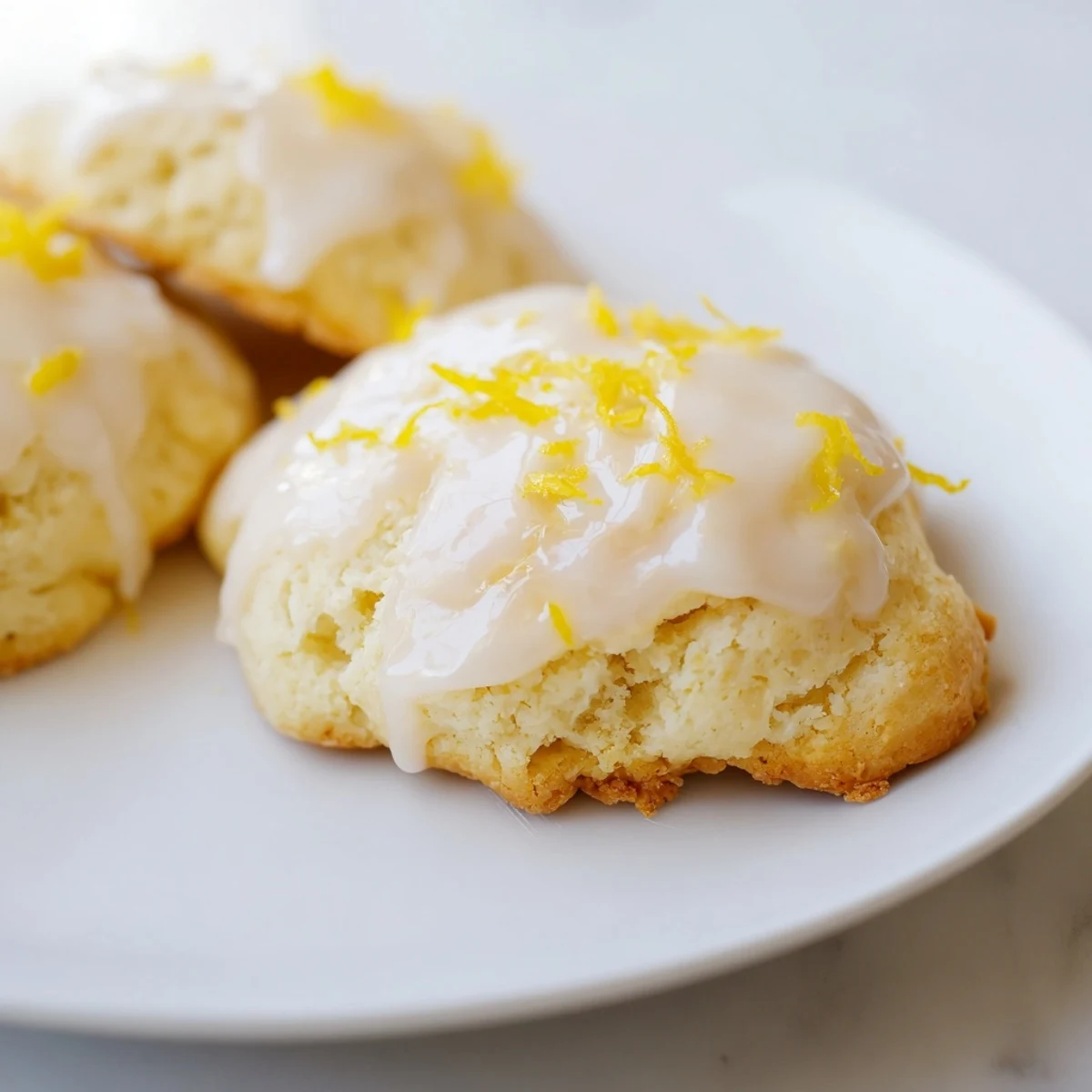 A platter of warm Lemon Ricotta Cookies drizzled with sweet glaze, perfect for spring afternoon tea.