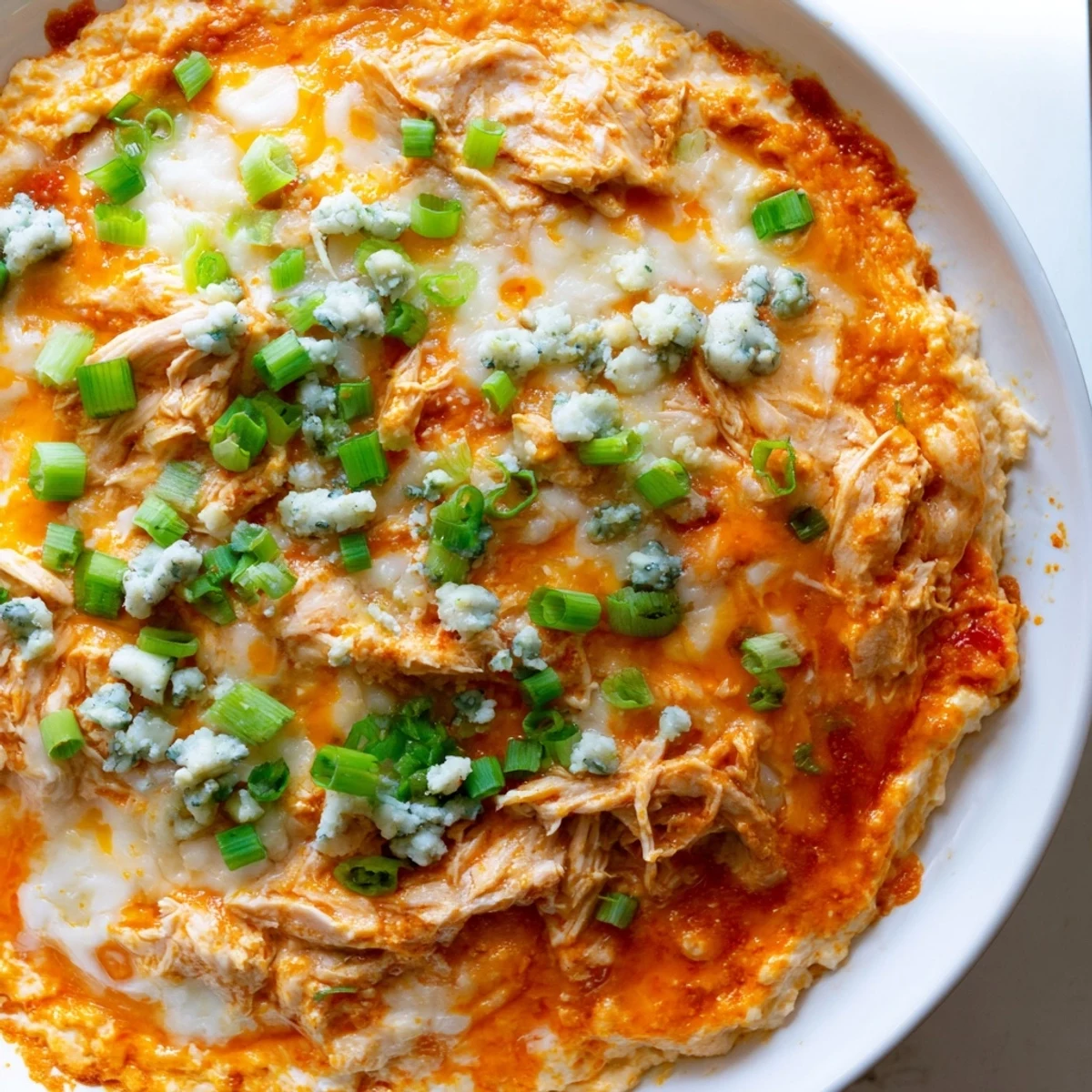 Bubbling Keto Buffalo Chicken Dip paired with keto-friendly crackers for an appetizer platter.