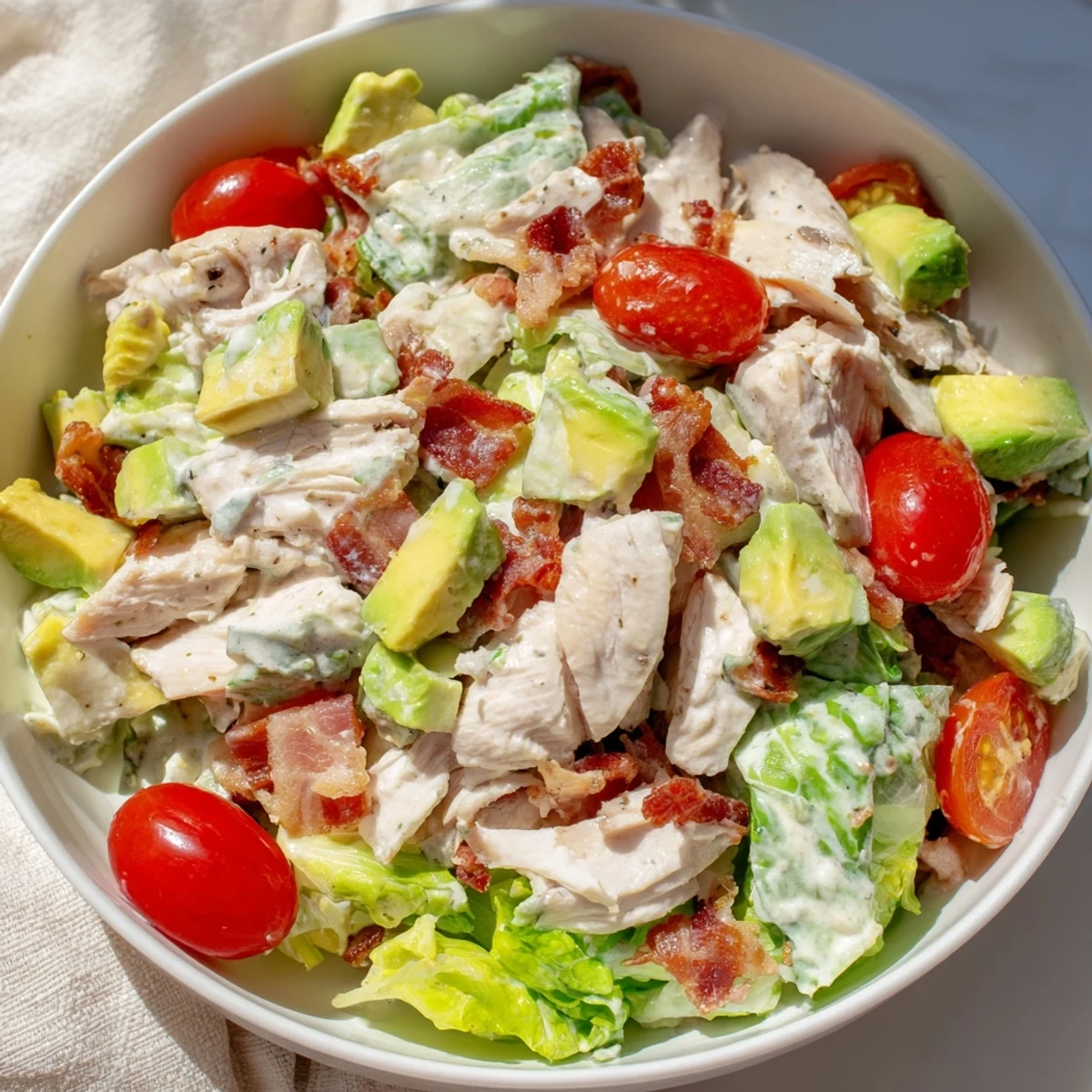 Crispy bacon and juicy chicken pieces in BLT Chicken Salad served over crunchy romaine lettuce.