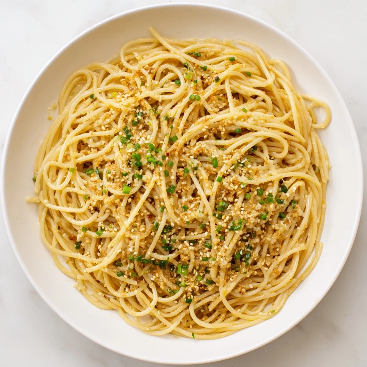 Cooking Garlic Noodles in a wok, featuring minced garlic and savory soy sauce, perfect as a flavorful side dish for dinner.