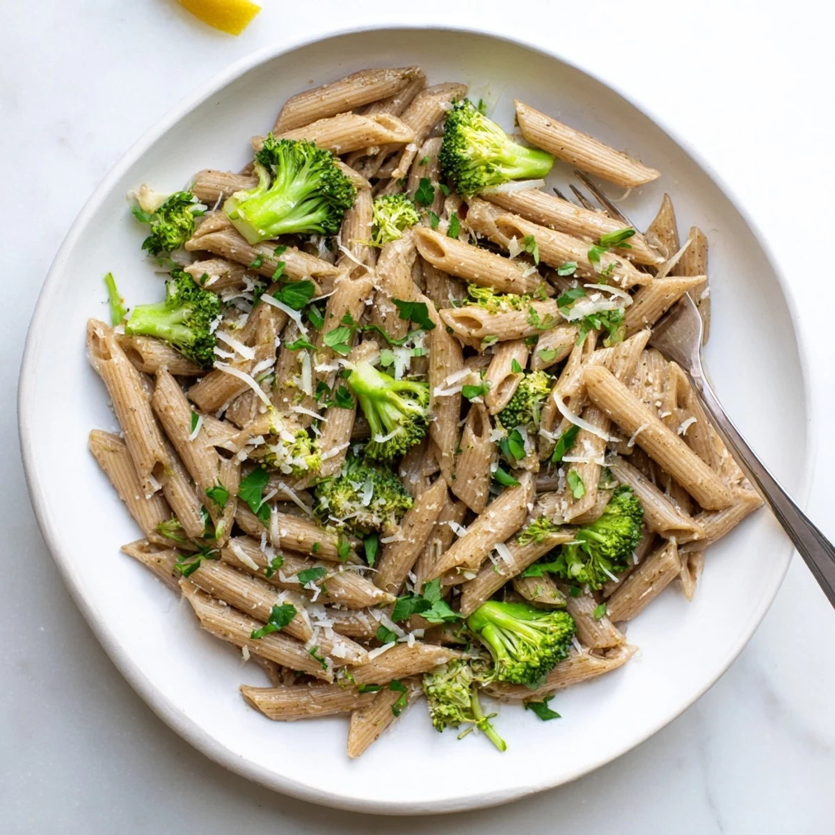 Steam rises from a skillet of Easy Healthy Broccoli Pasta, showcasing tender broccoli and al dente pasta coated in a light, glistening sauce.