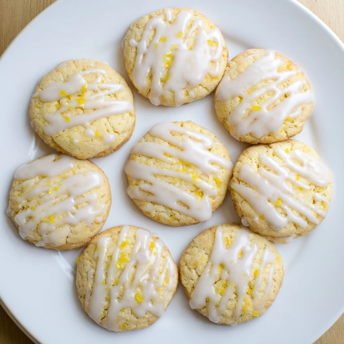 A close-up view of glazed Limoncello Cookies, showcasing their crackled tops and zesty lemon aroma, ideal for summer tea parties.
