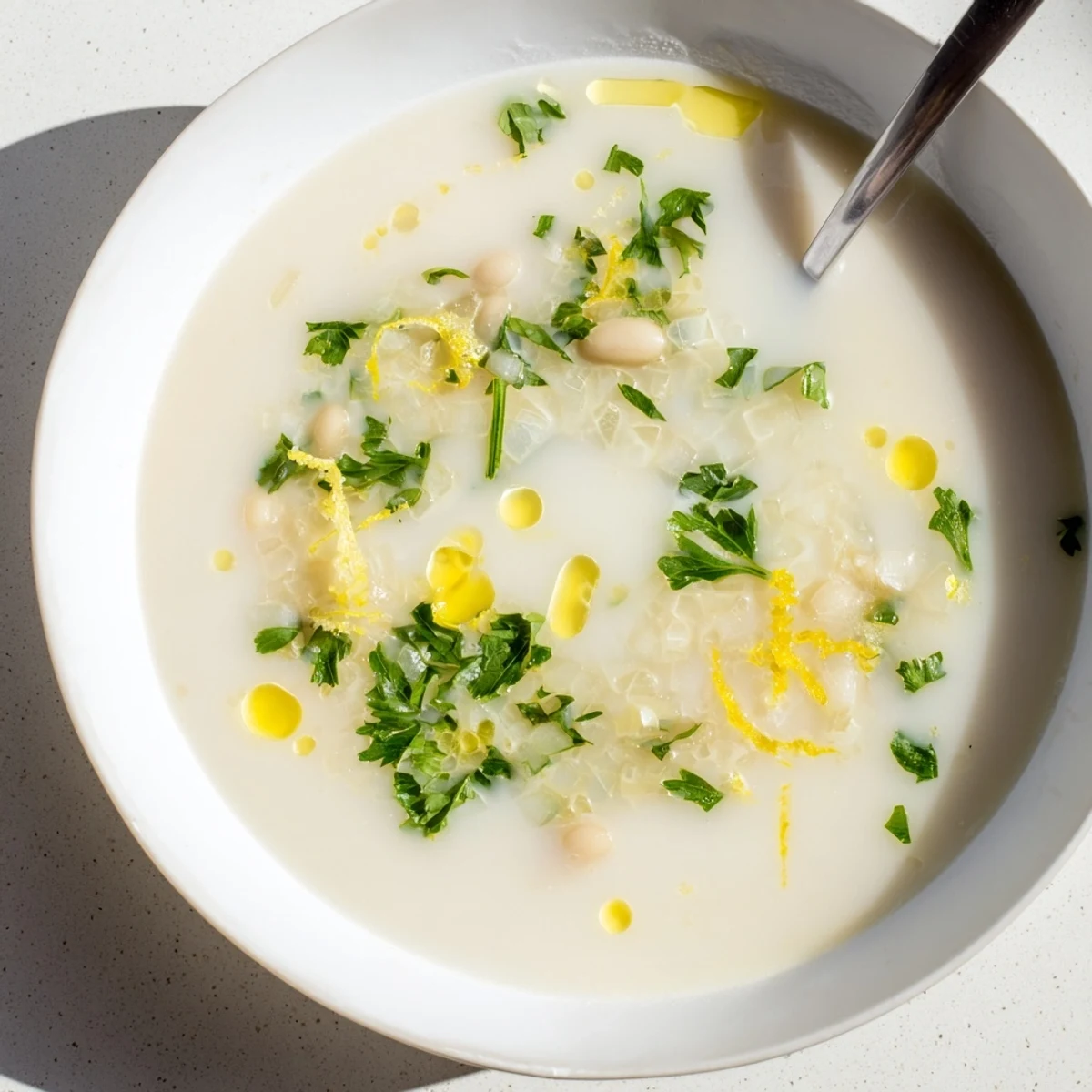 Creamy white beans simmered in savory miso-butter broth topped with fresh herbs and lemon zest