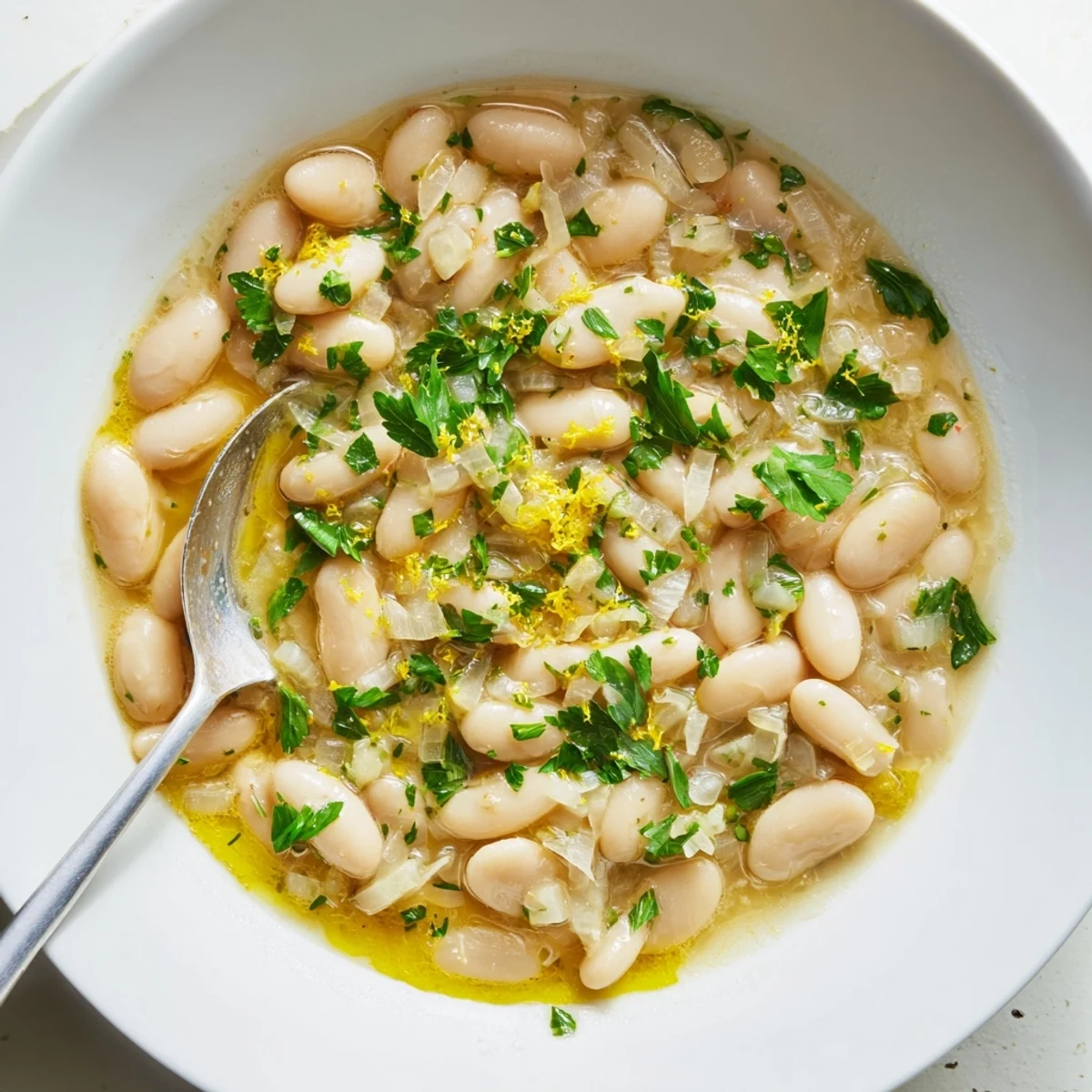 Steaming hot white beans in aromatic miso broth finished with bright chives and red pepper flakes