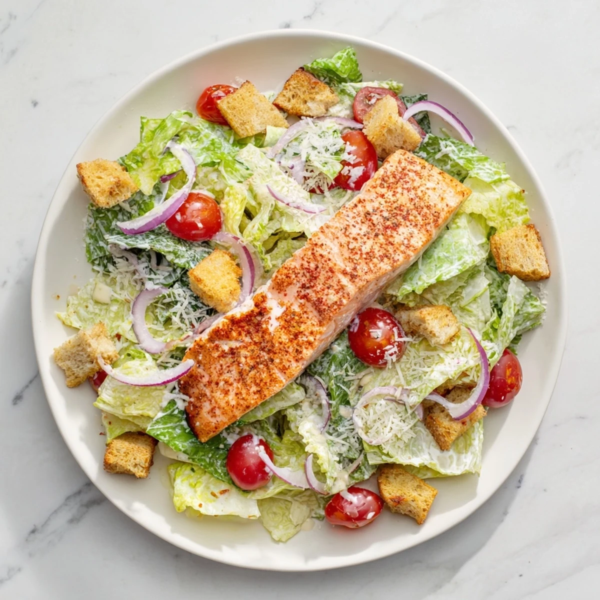 Vibrant salmon Caesar salad featuring flaky grilled fish, crunchy croutons, and Parmesan over fresh green romaine