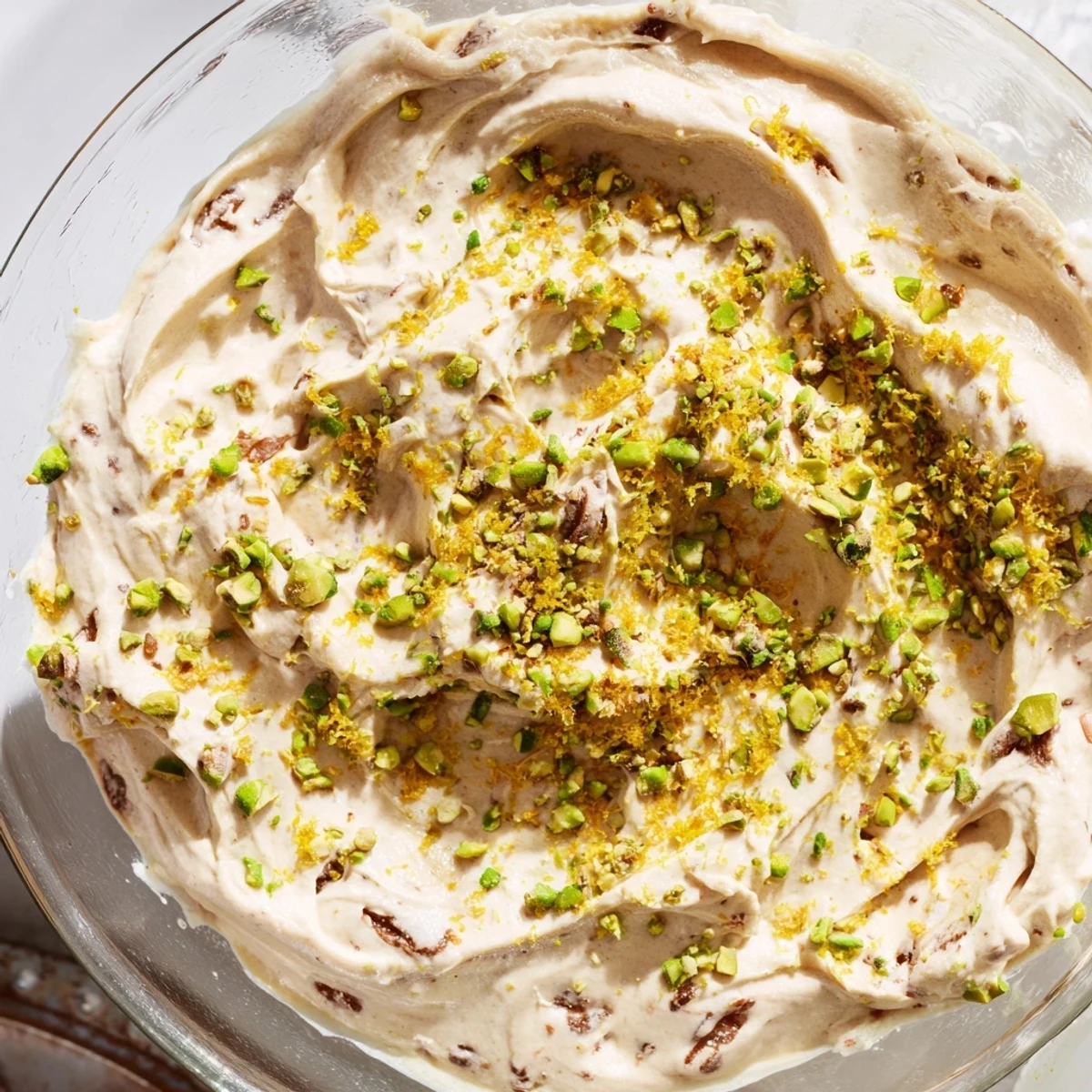 Creamy Lebanese date orange blossom mousse topped with pistachios and orange zest