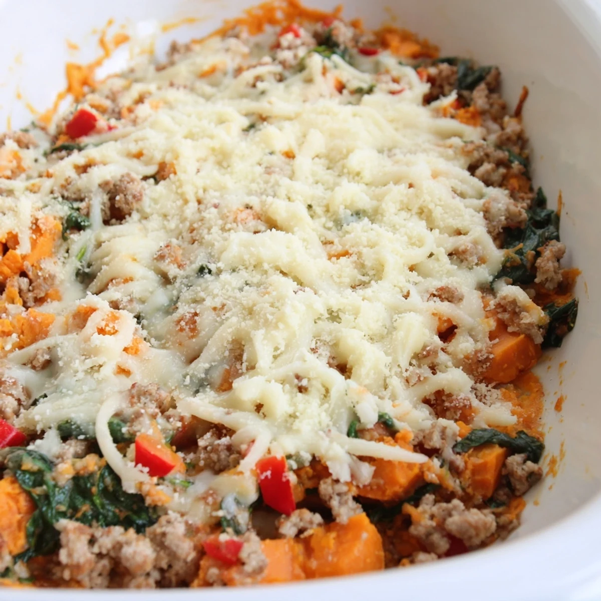 Golden ground turkey sweet potato bake casserole topped with bubbly melted mozzarella and Parmesan cheese