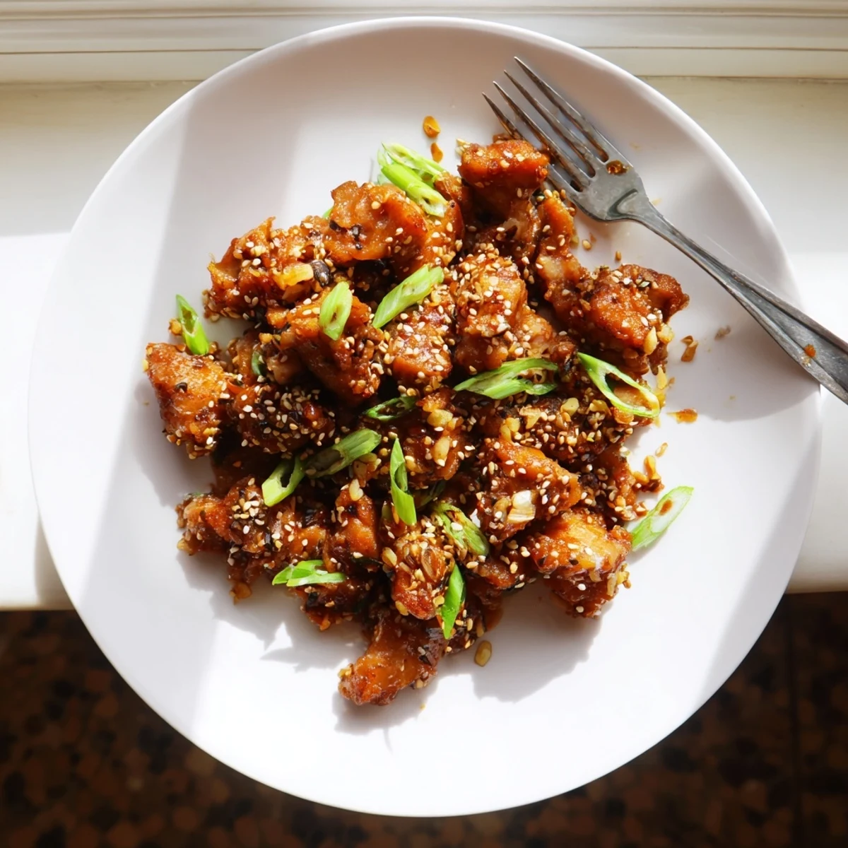 Golden Crock Pot Sesame Chicken glistening with sticky sauce and sesame seeds