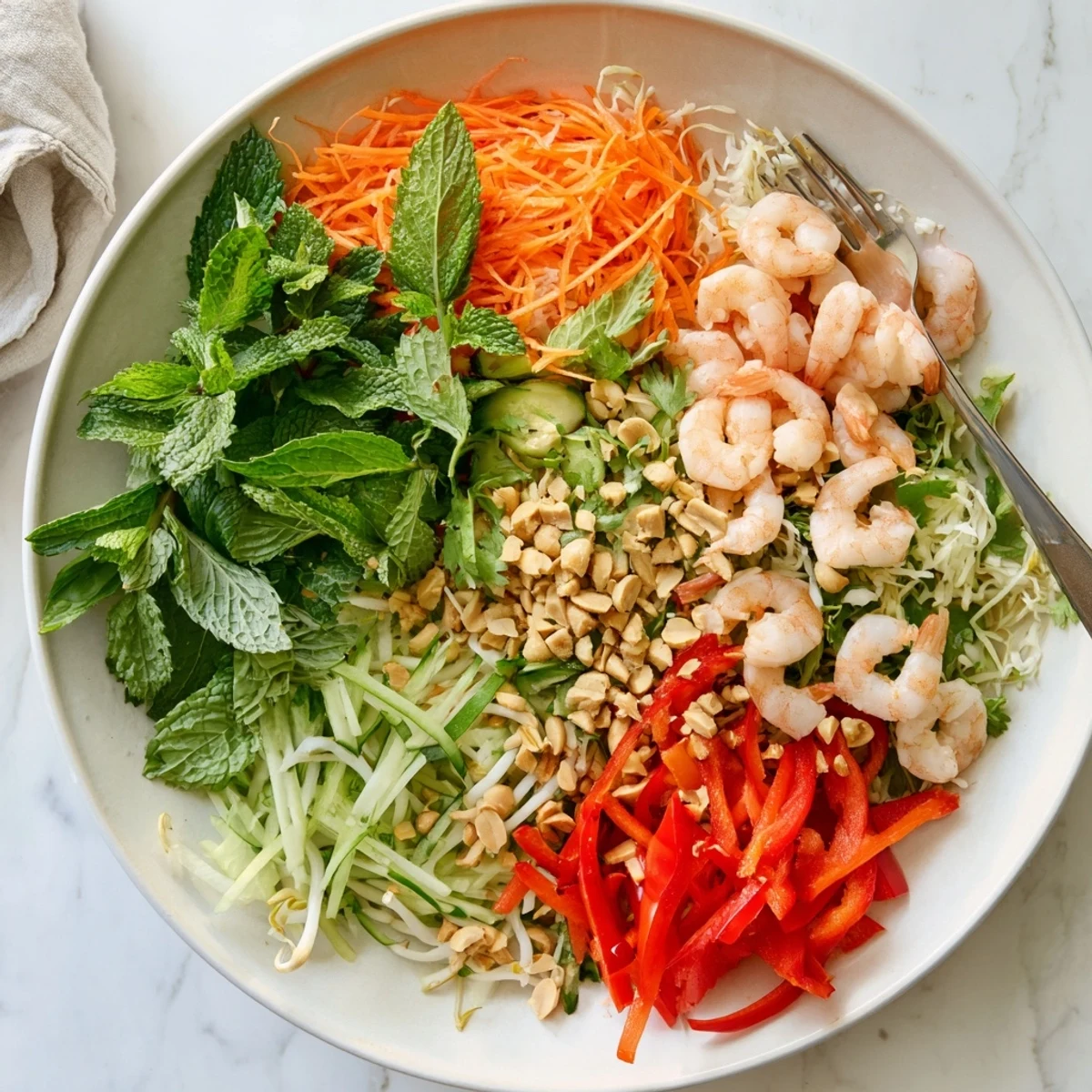 Vietnamese-style spring roll salad with spicy ginger dressing served over vermicelli noodles and topped with crunchy roasted peanuts