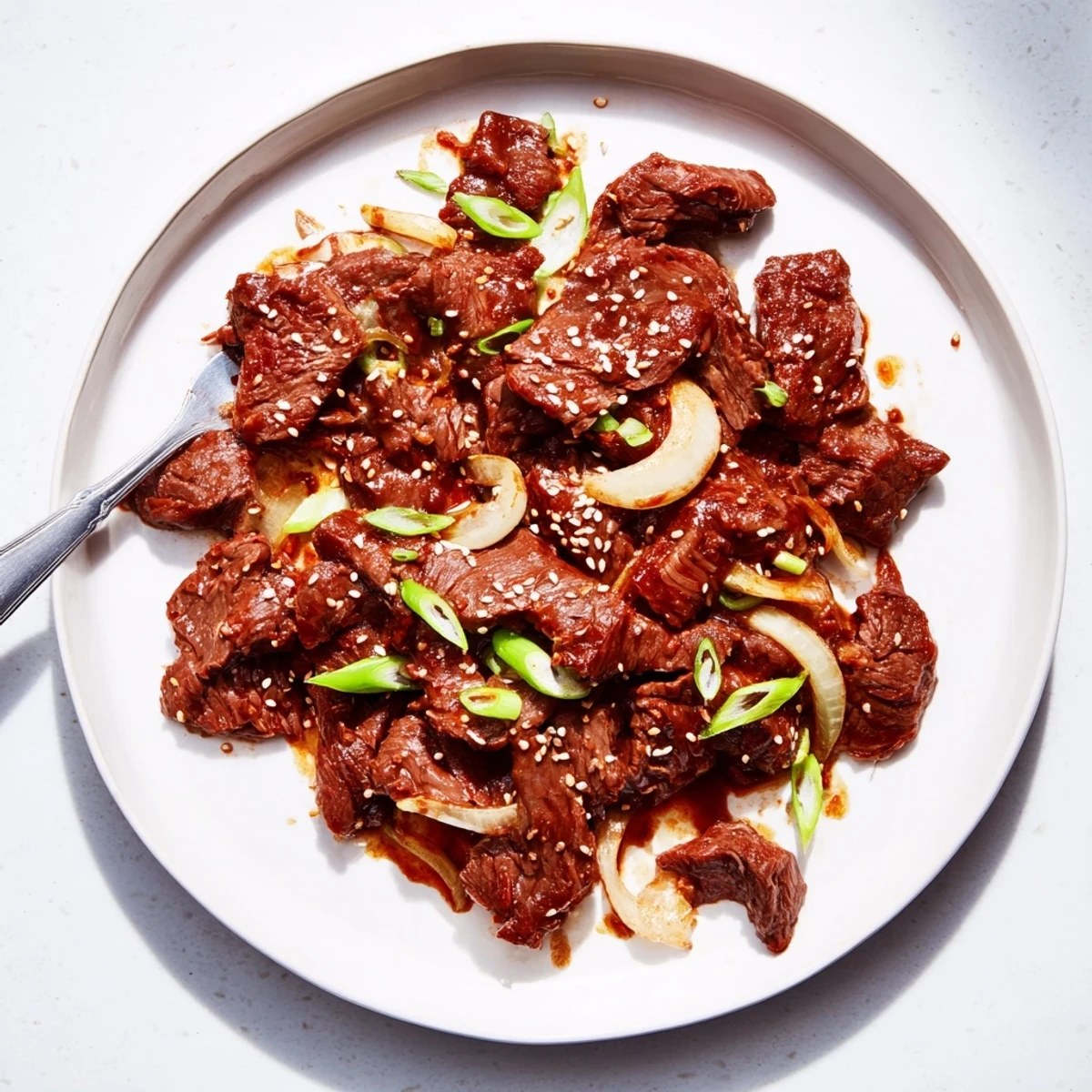 Slow cooker Korean beef featuring meltingly tender meat pieces coated in sweet and spicy glaze