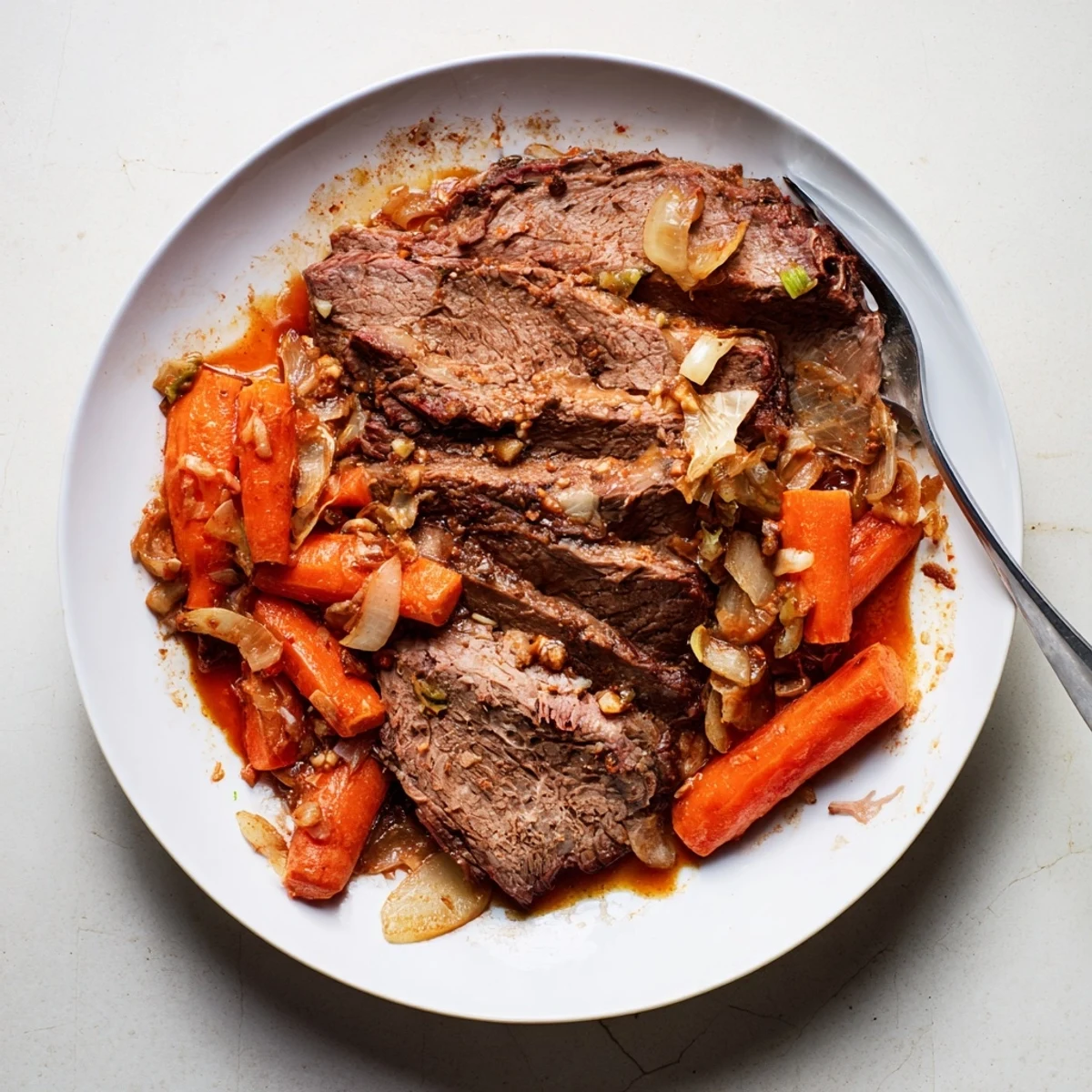 Tender slow cooker beef brisket slices with caramelized onions and rich savory sauce