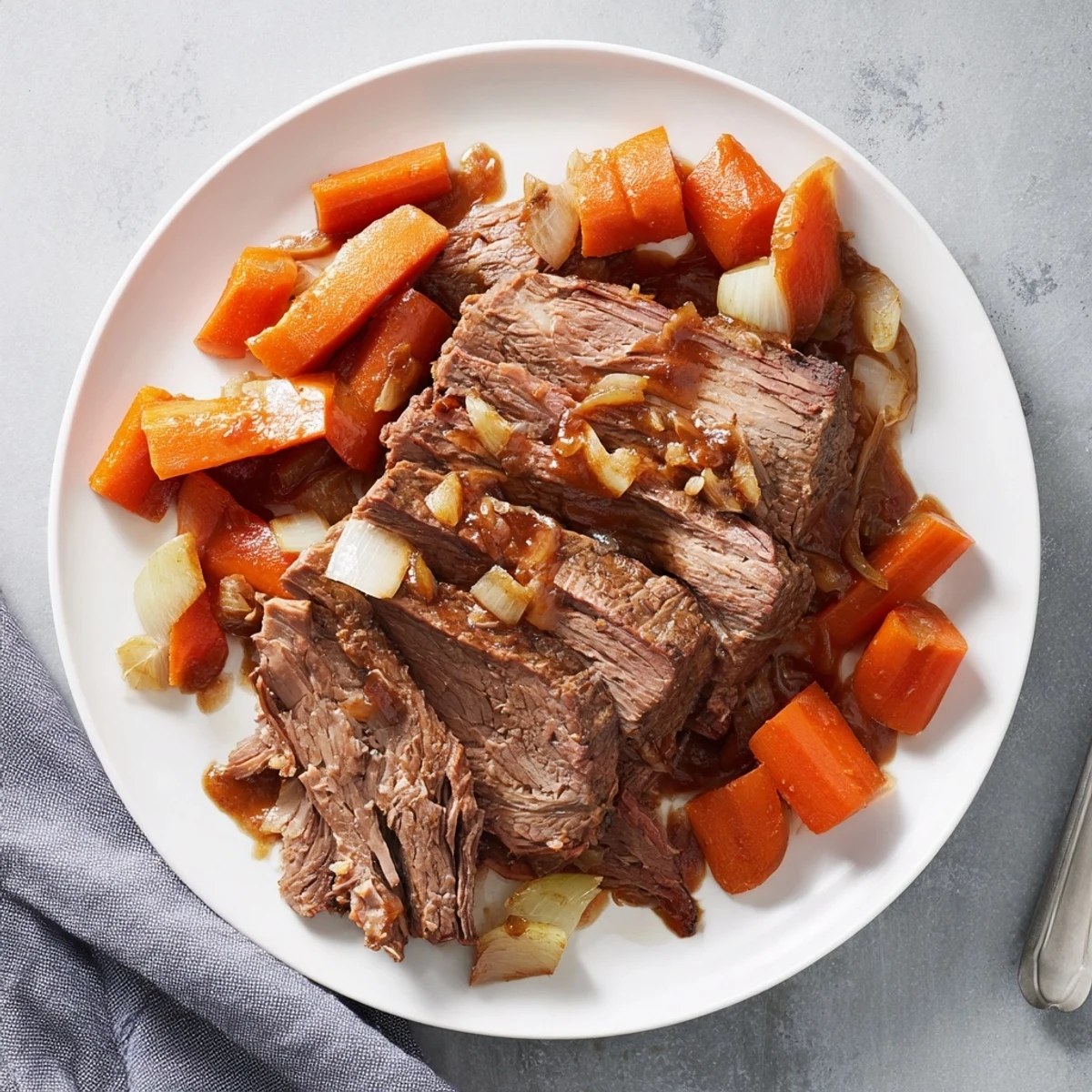 Fork-tender beef brisket slow-cooked for eight hours with vegetables in a dark glossy gravy