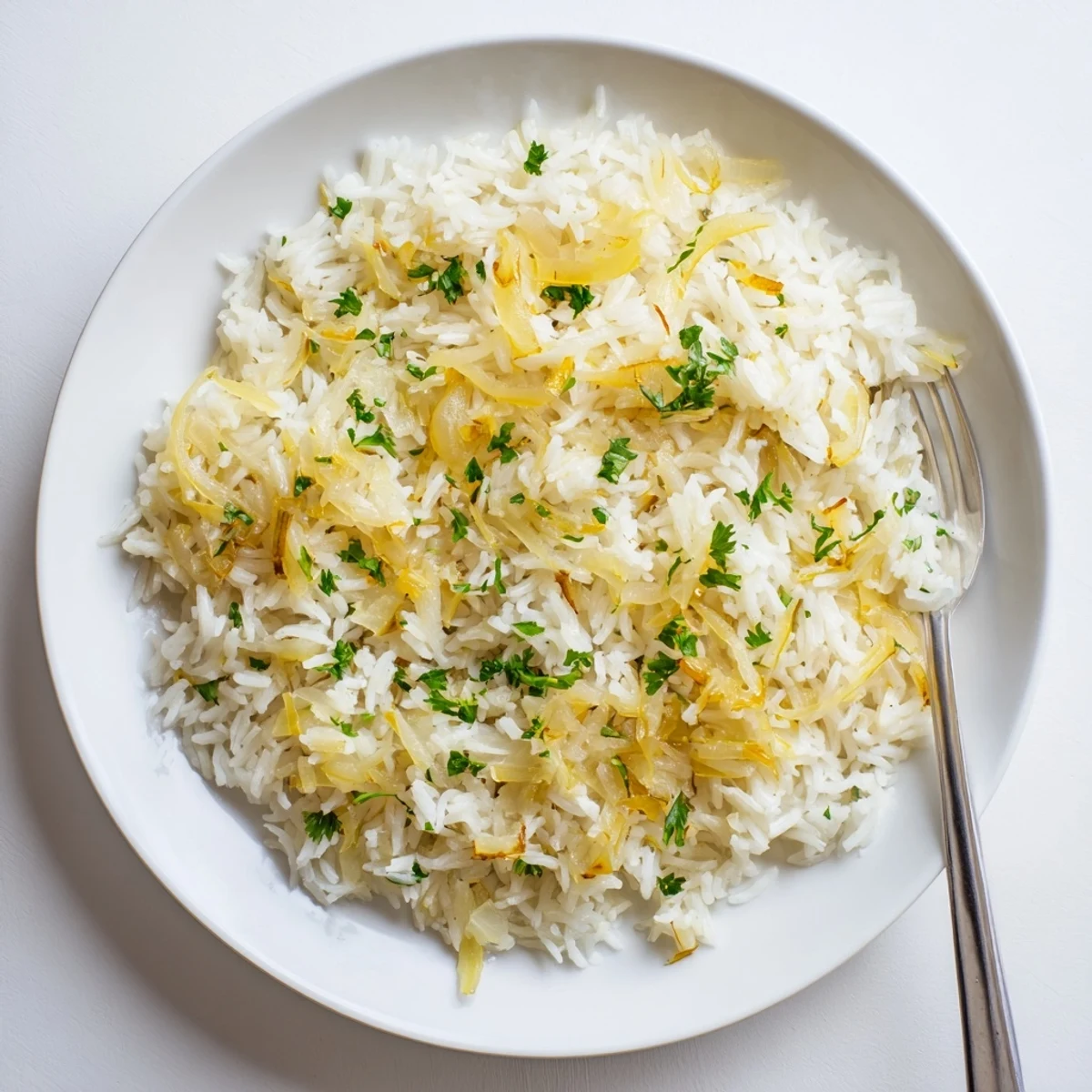Golden French onion butter rice flecked with fresh parsley and optional melted Gruyère cheese