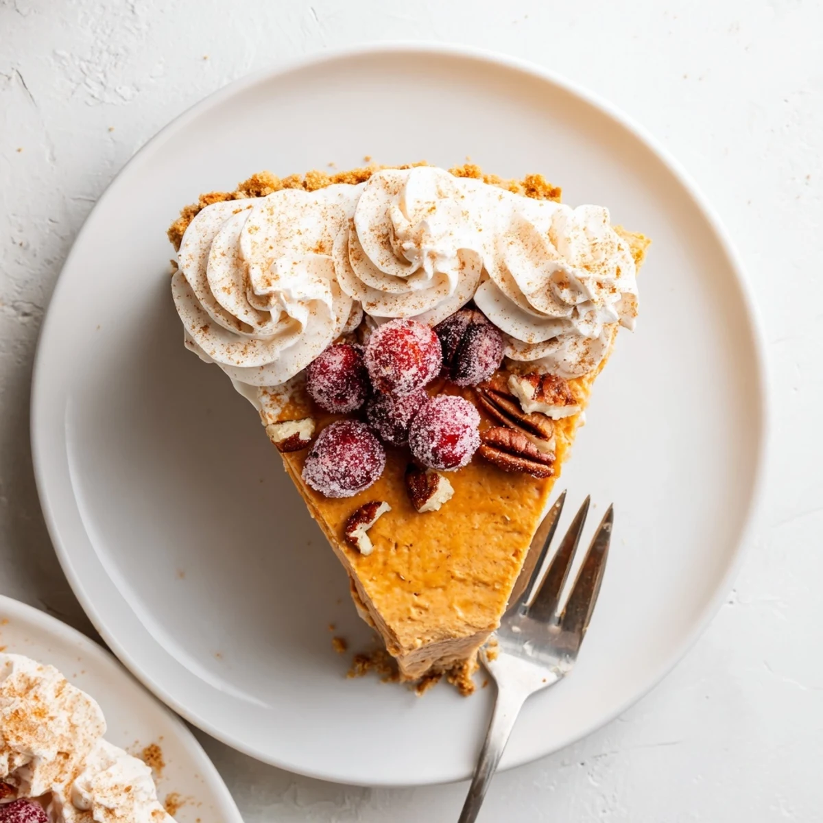 Festive Christmas cheesecake infused with pumpkin spice and topped with fluffy whipped cream