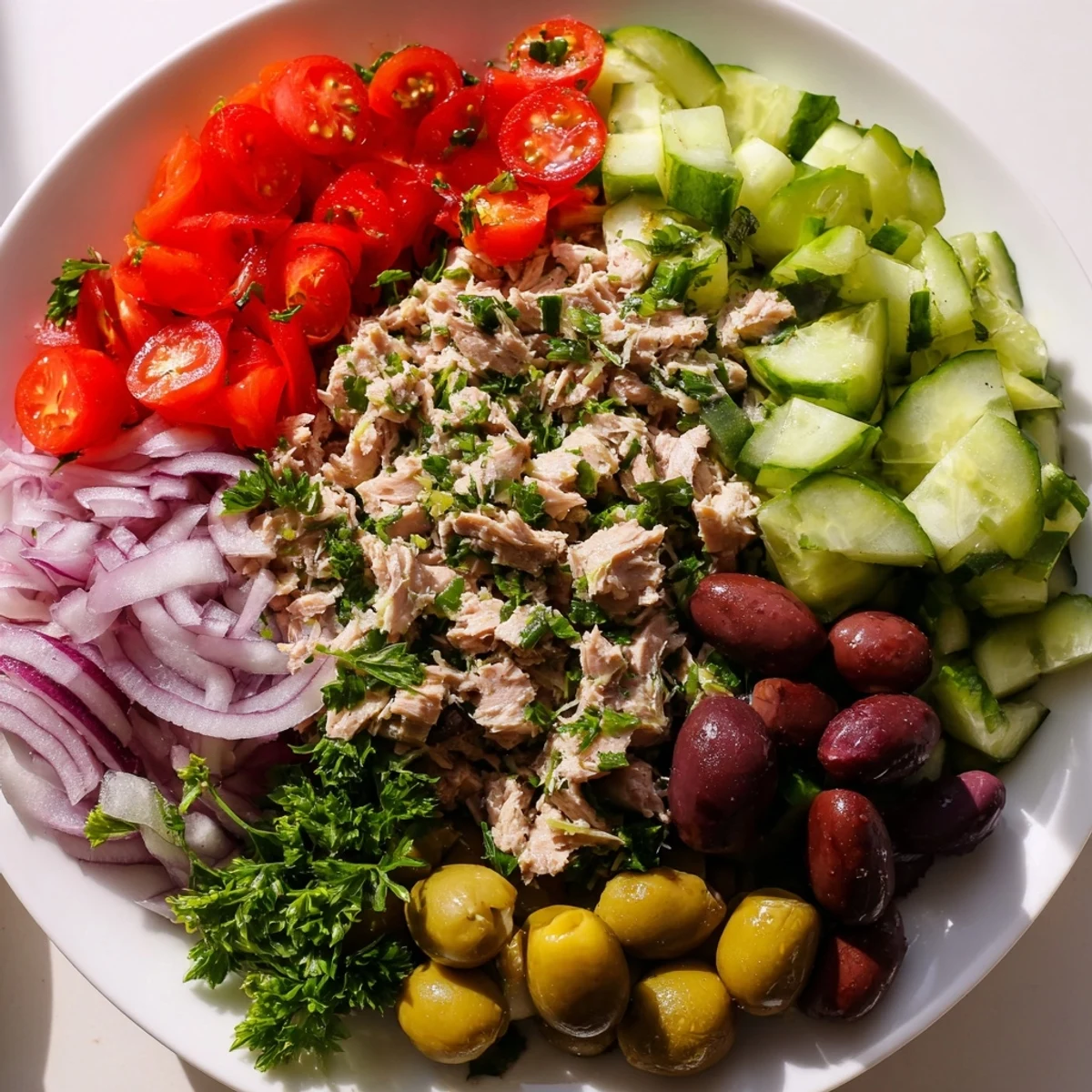 Simple Mediterranean Tuna Salad topped with crisp cucumber and a zesty lemon dressing