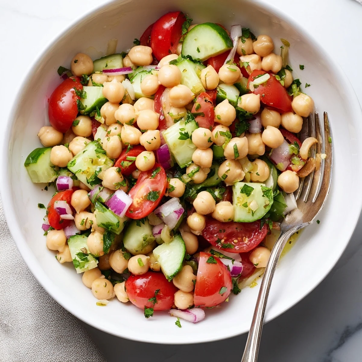 Crispy chickpea cucumber salad topped with ripe tomatoes and zesty vinaigrette