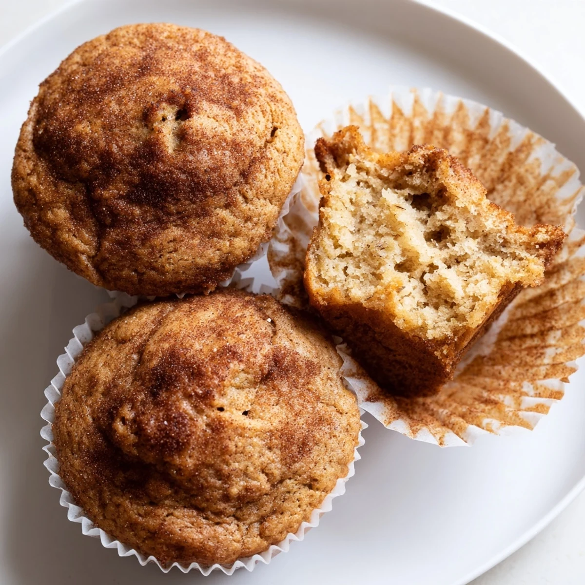 Moist banana muffins with cinnamon flecks served warm with a pat of sweet butter.