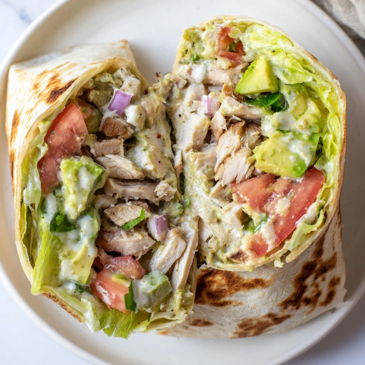 Golden-grilled Chicken Avocado Ranch Burritos served halved on skillet, toasty tortillas