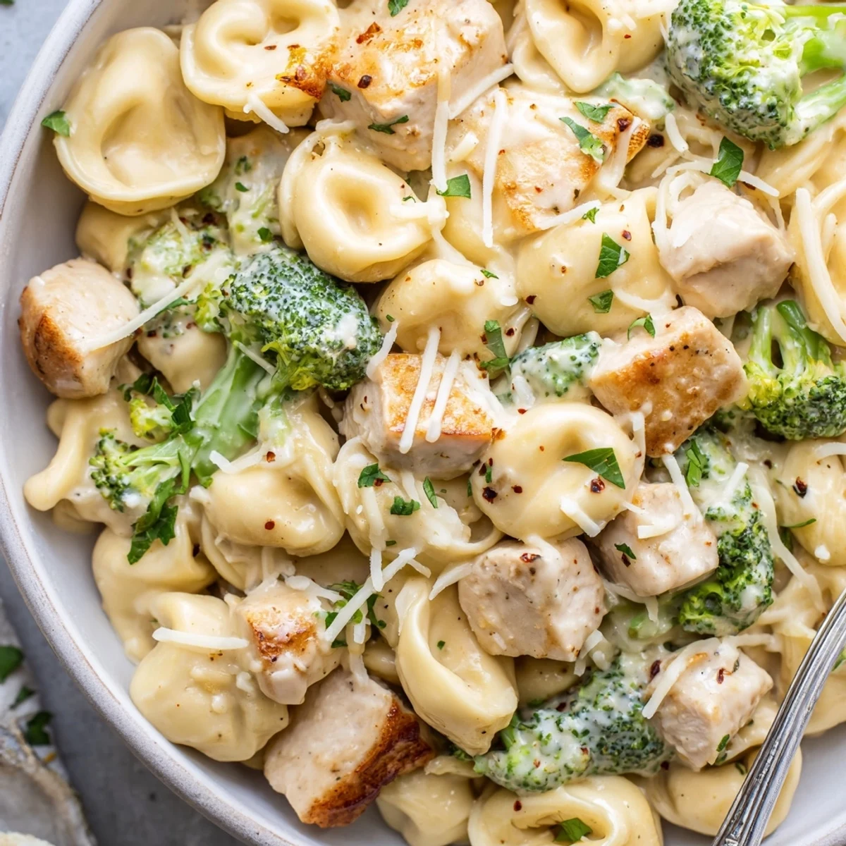Creamy Garlic Parmesan Tortellini Chicken Broccoli Recipe plated with rich sauce, tender broccoli