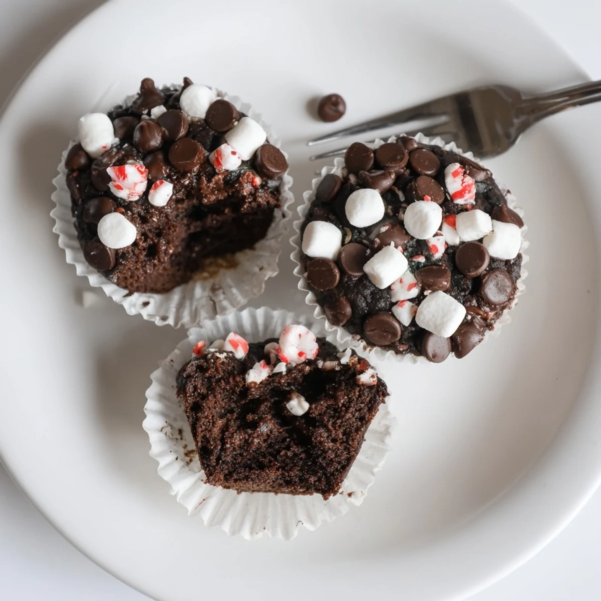 Peppermint Hot Chocolate Muffins with gooey chocolate chunks and crushed peppermint topping