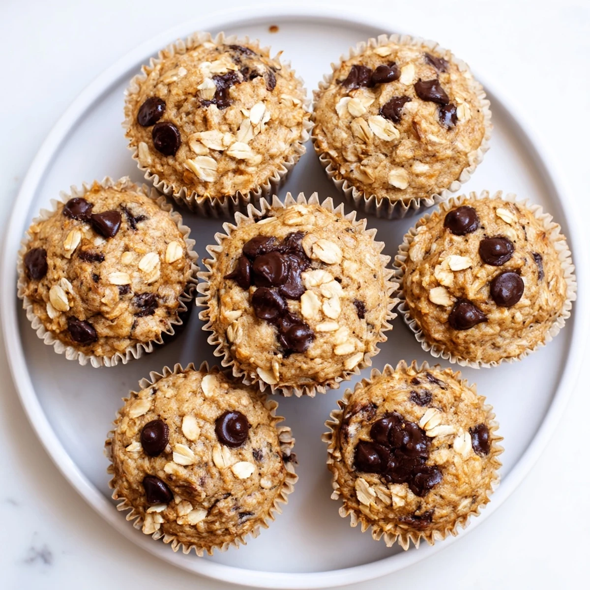 Batch of twelve wholesome banana oatmeal muffins with optional chocolate chip walnut additions