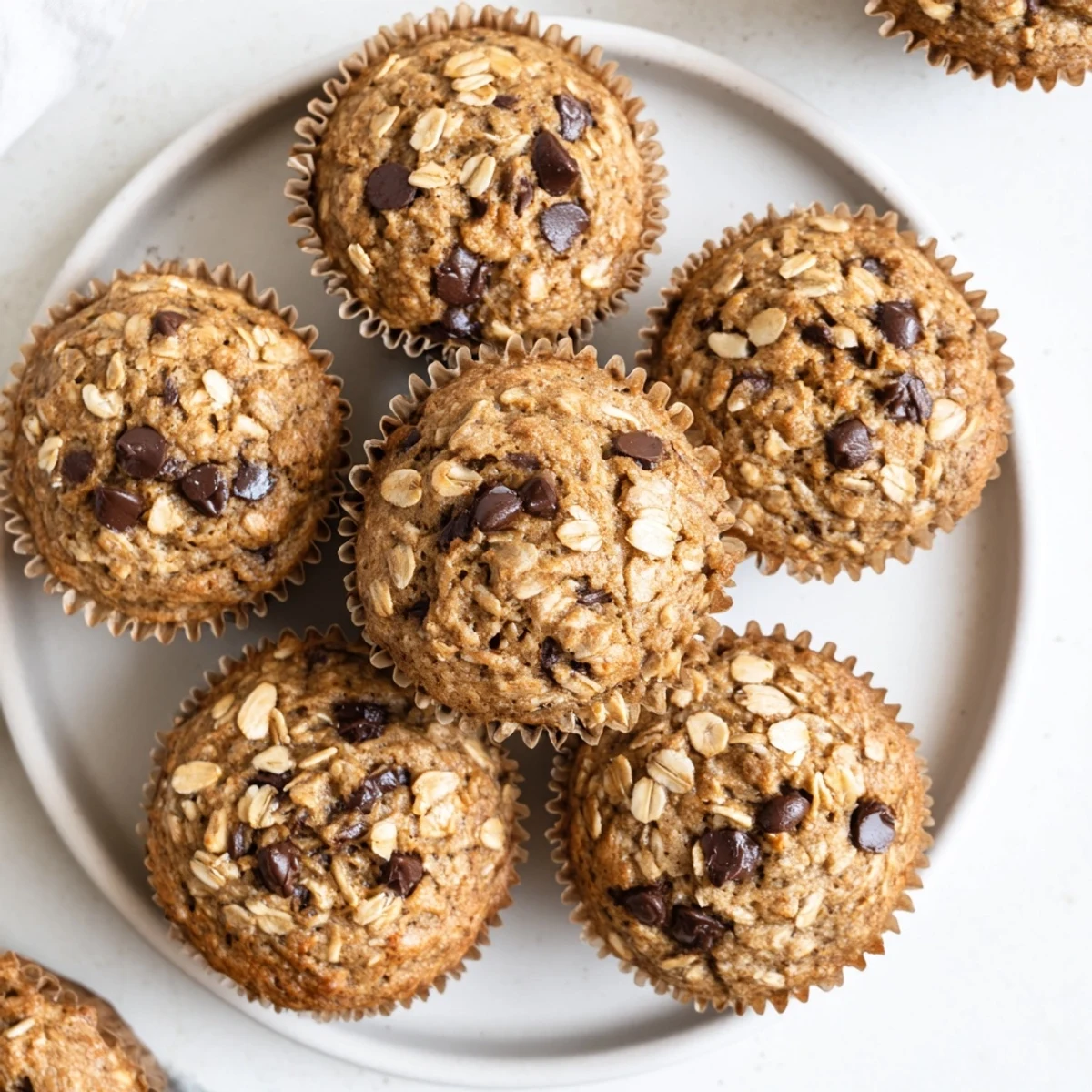 Moist banana oatmeal muffins split open showing tender crumb and mashed banana pieces
