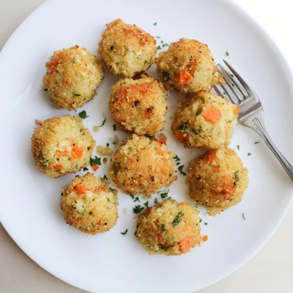 Fried Southern cornbread dressing balls with crunchy panko coating served alongside turkey gravy for dipping