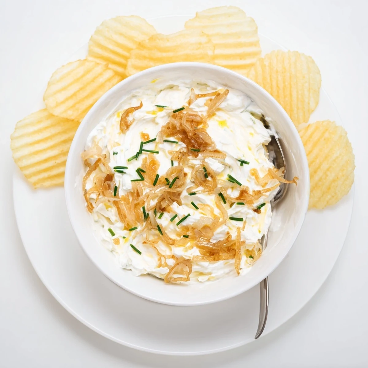 French onion dip with sweet sautéed onions garnished with green onions for party appetizer spreading