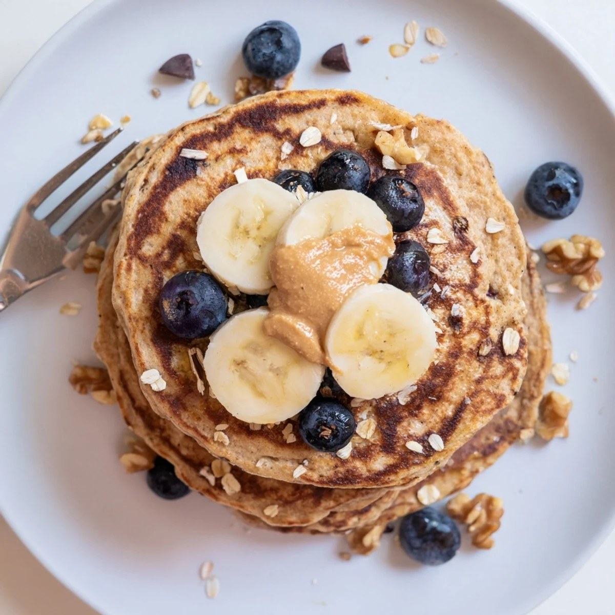 Homemade Protein Banana Pancakes cooked on griddle, tender, slightly cinnamon-scented