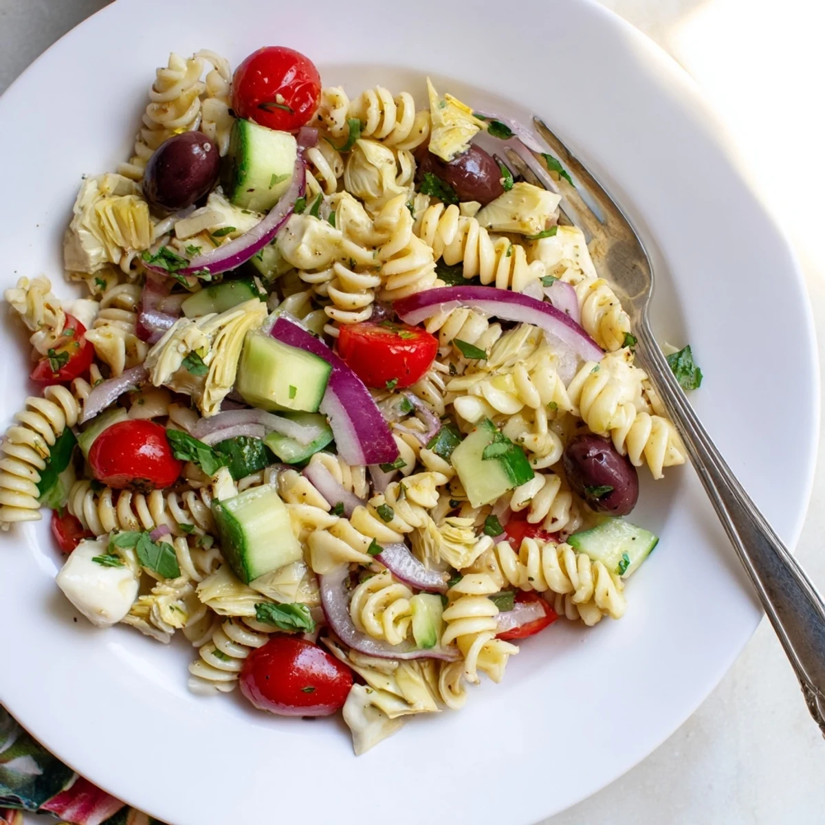 Colorful vegetarian Italian pasta salad loaded with crisp vegetables and tangy vinaigrette in a rustic bowl